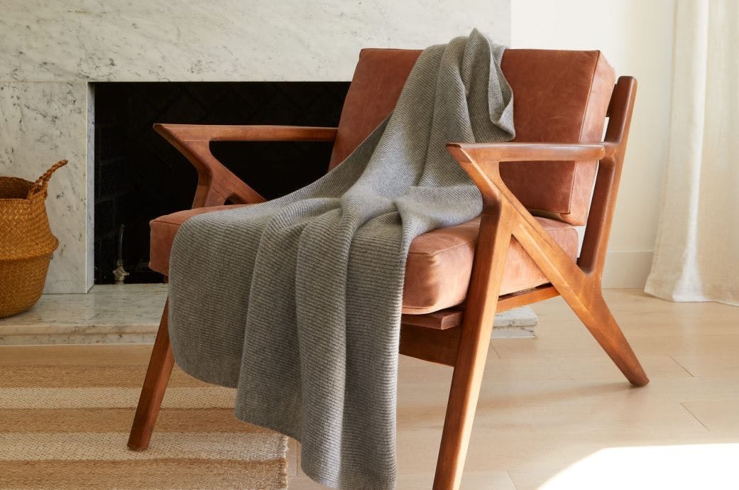 A picture of a cashmere throw on a couch