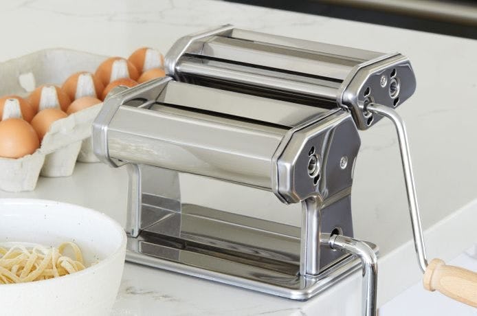 A countertop with a pasta maker